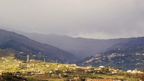Village in mountain valley fog hides Sicily, Italy timelapse.