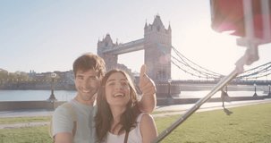 Tourist couple taking selfie smartphone in city sharing lifestyle photo enjoying holiday European vacation travel adventure London