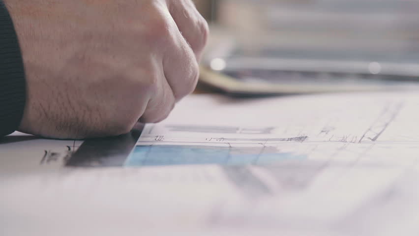Male architect at work. Architect Hands. Ruler and a pencil in the hand of the architect. Design of the house. Engineer. Tools for drawing. Creating a drawing. Architecture. Royalty-Free Stock Footage #25053314