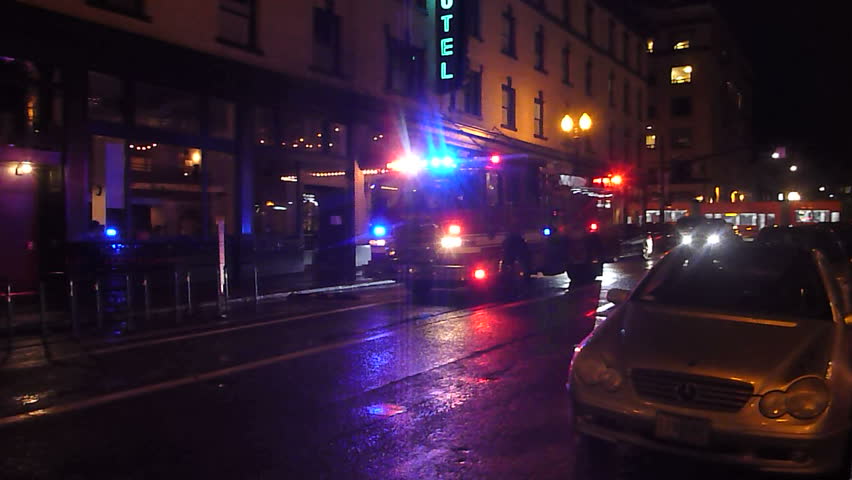 PORTLAND, OREGON - CIRCA 2017: Firefighters arrive in firetruck to respond to a call at night in downtown Portland, Oregon. | Shutterstock HD Video #25054673