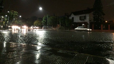 BUENOS AIRES, ARGENTINA - CIRCA APRIL, 2016: Heavy rain night avenue traffic front shot
