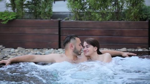 Couple resting in the jacuzzi.