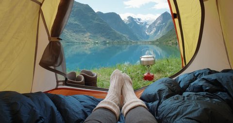 Camping woman lying in tent Close up of Girl feet wearing hiking boots relaxing on vacation POV 库存视频