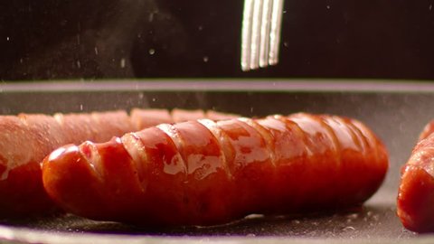 Frying Sausages - slow motion 