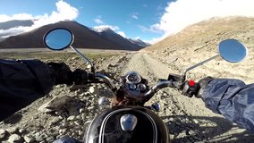 Off-road motorcycle riding around scenic mountains landscape