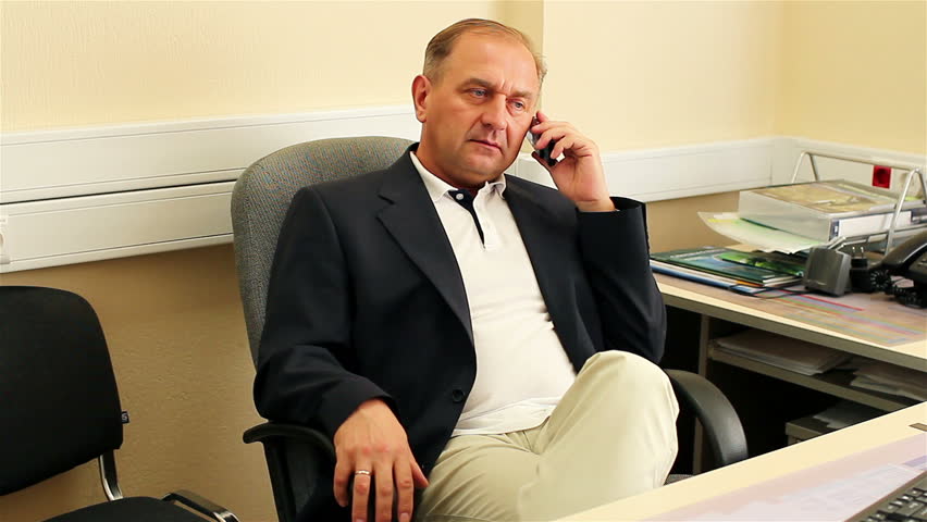 Businessman talking on the phone. Businessman calling on mobile phone in office