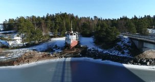 Cinema 4k aerial around a rusty old boat, at Barolandet near Barosund or Baronsalmi of the finnish archipelago, of Inkoo, Finland