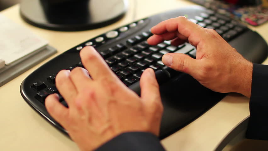 Close-up of male hands typing on keyboard. Male hands typing.