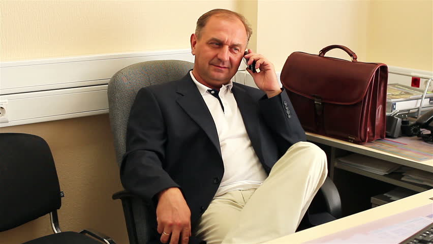 businessman speaking on the phone at the office table