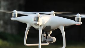 Slow motion close up video of a white quadcopter drone hovering in an ancient italian town, HD