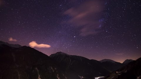4K Time-lapse of a beautiful cloudy starry dark night with the Milky Way, Orion and Jupiter