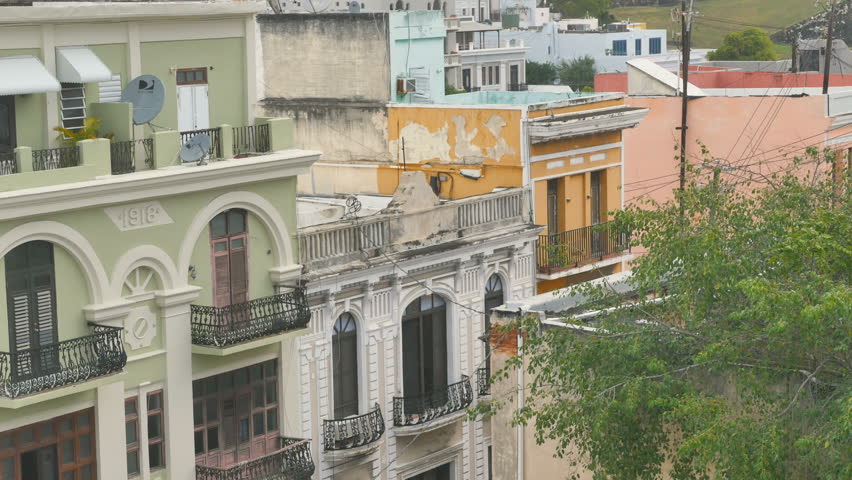 Roof top vegetation gently blowing view of old town San Juan, Puerto Rico upper levels of the buildings lining Portaleze street on this Caribbean Island destination port.
