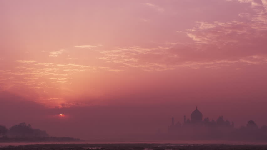 Time lapse of Taj Mahal at sunrise from Yamuna river in Agra, Uttar Pradesh, India. All birds from the sky are removed. Royalty-Free Stock Footage #25094198