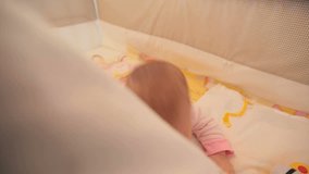 Sweet baby crawling in his crib. Video full hd.
