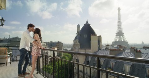 Romantic couple in Paris Eiffel Tower embrace kissing honeymoon enjoying European summer holiday travel vacation adventure
