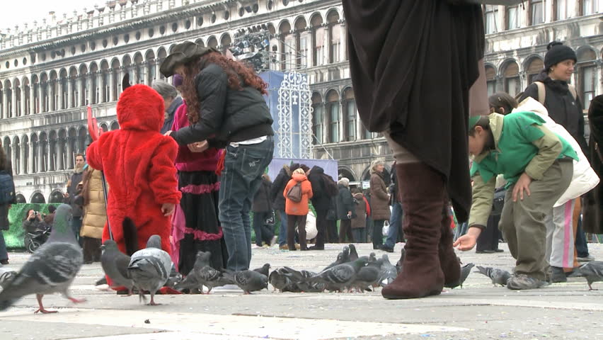 VENICE - FEBRUARY 24: Feeding pigeons on St. Marks Square on February 24, 2009