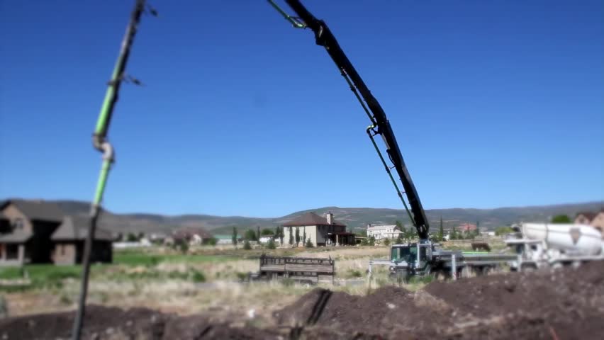 Cement pump truck pouring foundations for a house