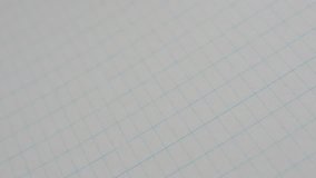 Panning on empty school book internal white surface 4K 2160p 30fps UltraHD footage - Slow pan classic squared paper notebook writing surface 3840X2160 UHD video - Powered by Shutterstock - Get 15% off with code: PIKWIZARD15