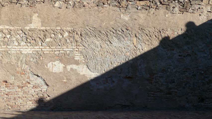 Shadows on wall in Alcazar de Gibralfaro, is Castle fortification located in Spanish city of Malaga. Phoenician enclosure contained lighthouse that gives name to hill Gibralfaro.