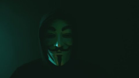 Aachen, Germany - March 01, 2017: Studio shot of Anonymous computer hacker wearing Guy Fawkes vendetta mask on March 01, 2017. 