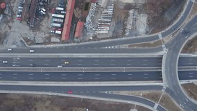 aerial view of traffic circle roundabout, interstate bridges crossing at highway junction, top view from drone of huge motorway through countryside, white road markings on grey asphalt, autobahn