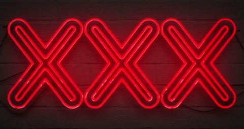 flickering blinking red neon sign on brick wall background, sexy adult show night club xxx sign concept