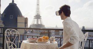 Tourist Man looking at Eiffel Tower Paris from hotel balcony wearing virtual reality headset watching 360 video imagination concept