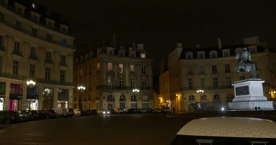 Paris at night street view, circle roundabout, monument, traffic.
