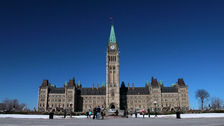 Parliament Hill in Ottawa centered in a wide shot with tourists out front
