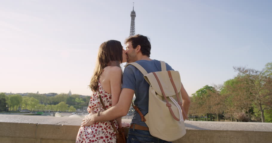 Young couple holding hands woman leading boyfriend walking towards Eiffel Tower Paris POV travel concept