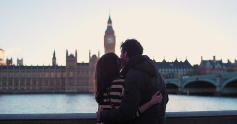 Tourist couple kiss in love in city at sunset enjoying lifestyle holiday European vacation travel adventure London