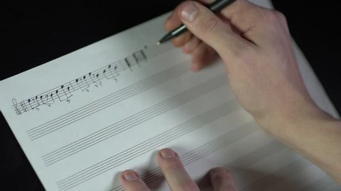 timelapse of composer writing music by hand