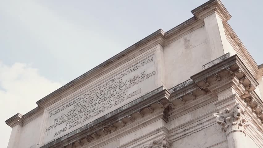 Close-up view of the Arch of Titus in Rome, Italy. Camera moving down.