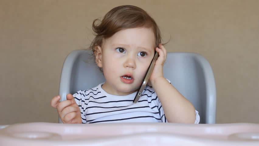 Baby girl talking on the phone Royalty-Free Stock Footage #25143590