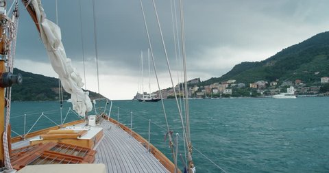 Uncertainty concept Wooden luxury sailboat sailing over ocean in beautiful blue mediterranean sea