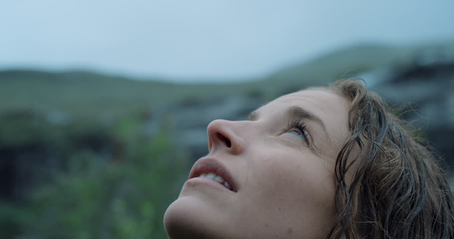 Close up portrait of Woman looking up at rain in nature with wet hair Hiker Girl trekking in Scotland Slow Motion Royalty-Free Stock Footage #25164725