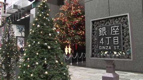 Tokyo, Japan - CIRCA November, 2006: Ginza Street sign with a Christmas tree in the background Editorial Stock Video