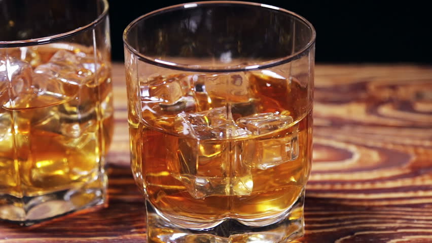 Glasses of malt whiskey on a black table. video slider | Shutterstock HD Video #25166306