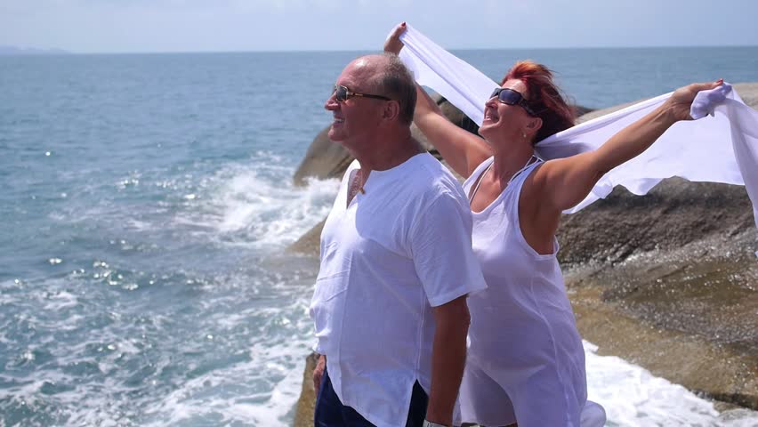 Senior Couple in White Clothes Enjoying Sea on Vacation