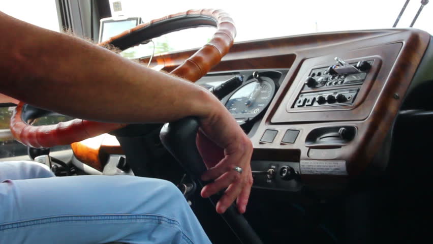 man's hand driving in bus