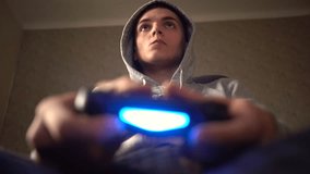 Young Man Absorbed In Online Video Game. Controller, console, gamepad