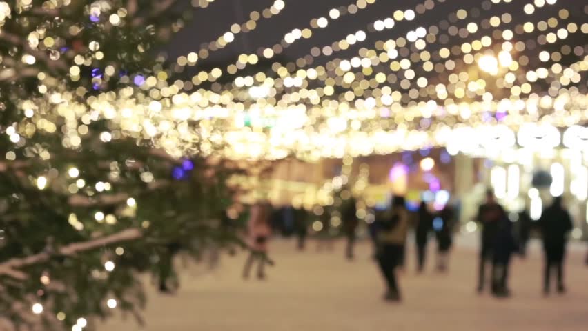 People walking on Christmas market. Christmas shopping/People silhouettes walking on the Christmas market. Strong back light from small cabins on the market.  | Shutterstock HD Video #25170575