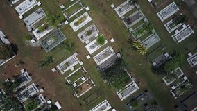 Aerial Footage - Bird's eye view of a Muslim Cemetery. Camera/Drone moving up revealing the arranged of the graves like patterns.