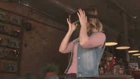 woman uses virtual reality glasses in cafe