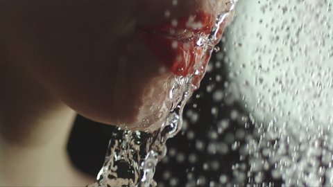 woman taking a shower in slow motion. beautiful girl enjoying herself during a shower. close up of the neck and the mouth