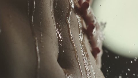 woman taking a shower in slow motion. close up of a tummy when a young woman wash and enjoy herself under a shower 