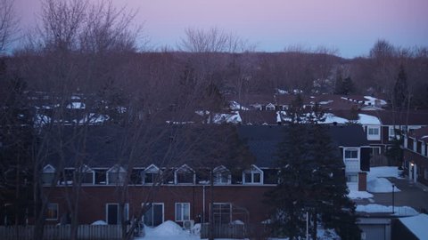 DAY TO NIGHT TIME-LAPSE: Canadian Neighborhood Townhouses - Winter Sunset & Airplanes Flying Above