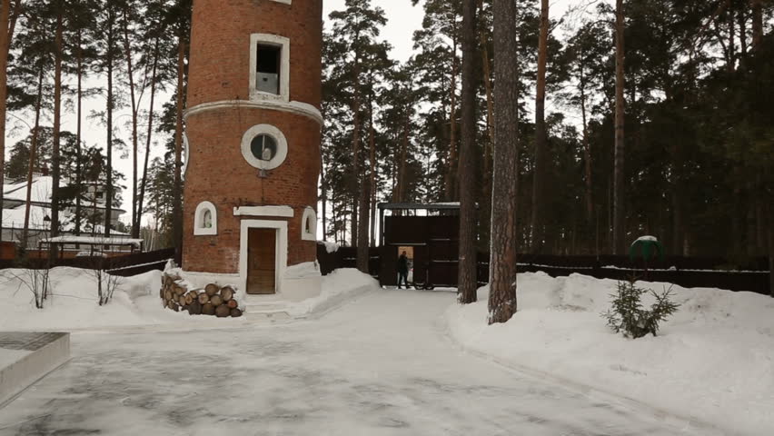 Tower in the Novosibirsk region in Berdsk. The age of the building is 100 years. A low, old tower in the forest.