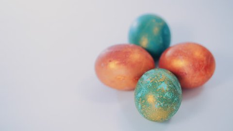 Red and green Easter eggs on white background.