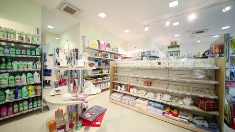 Light turns off and turns on in the department with utensils, household chemicals and hair care products in the home goods store